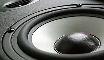 Haut-parleur symbolisant la puissance de la communication sonore chez ATS Studios.