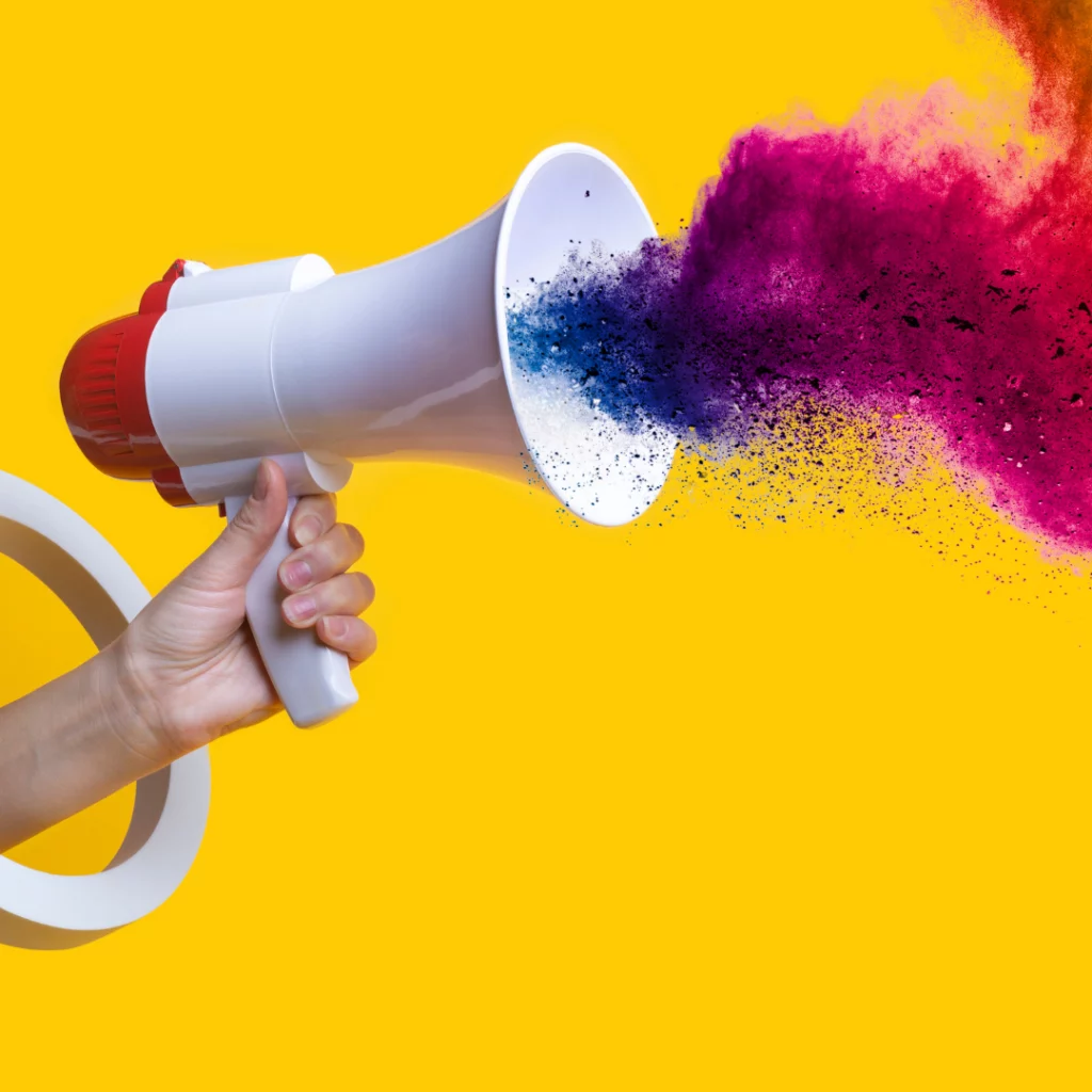 Un mégaphone diffusant des poudres colorées, symbolisant l’impact créatif d’une identité musicale de marque.